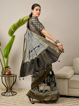 ADHIRA-Elegant black saree featuring intricate traditional mythological and folk art inspired prints