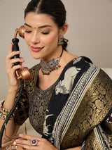 ADHIRA-Elegant black saree featuring intricate traditional mythological and folk art inspired prints