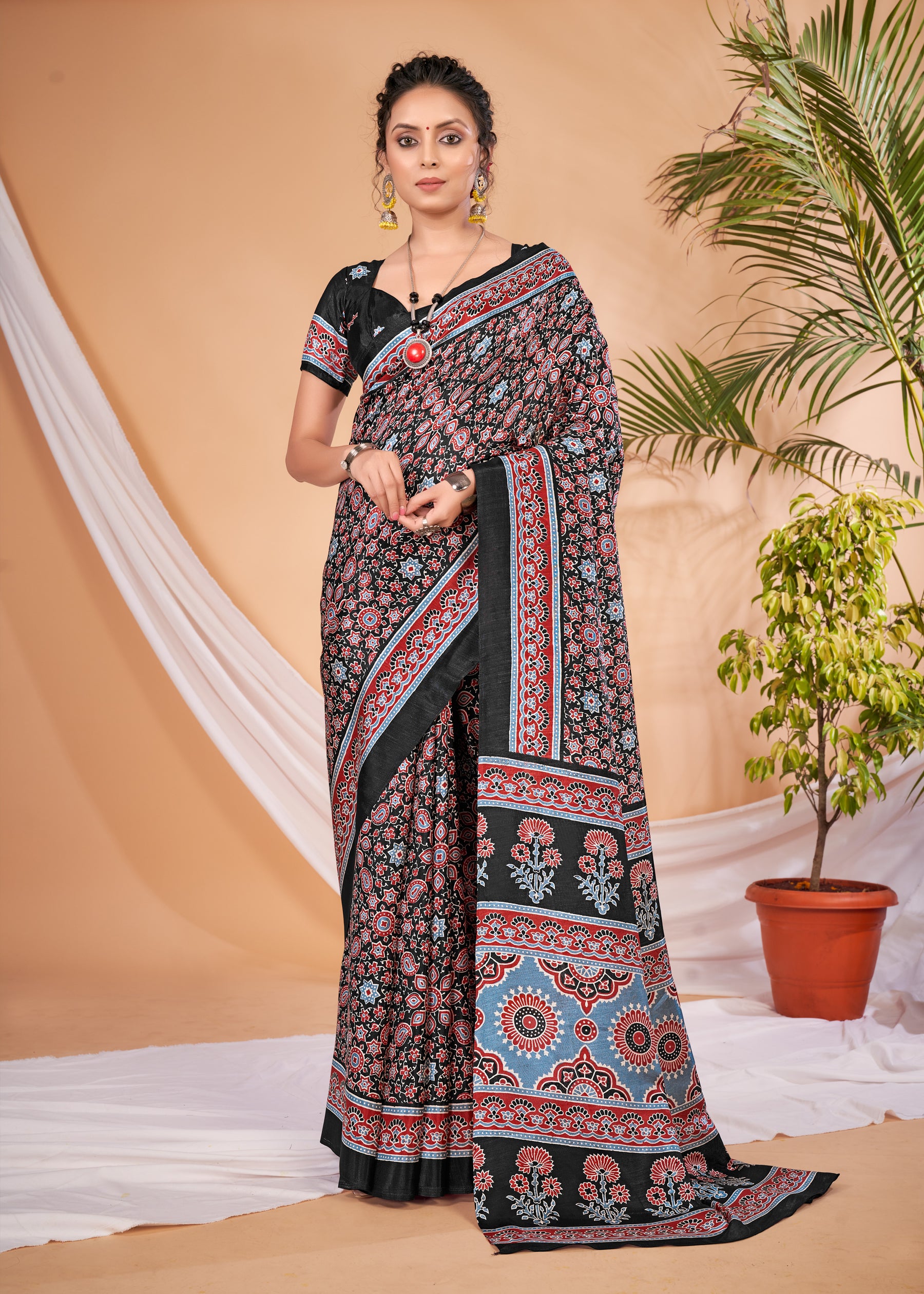 KUMRANElegant black saree with intricate traditional floral and geometric prints