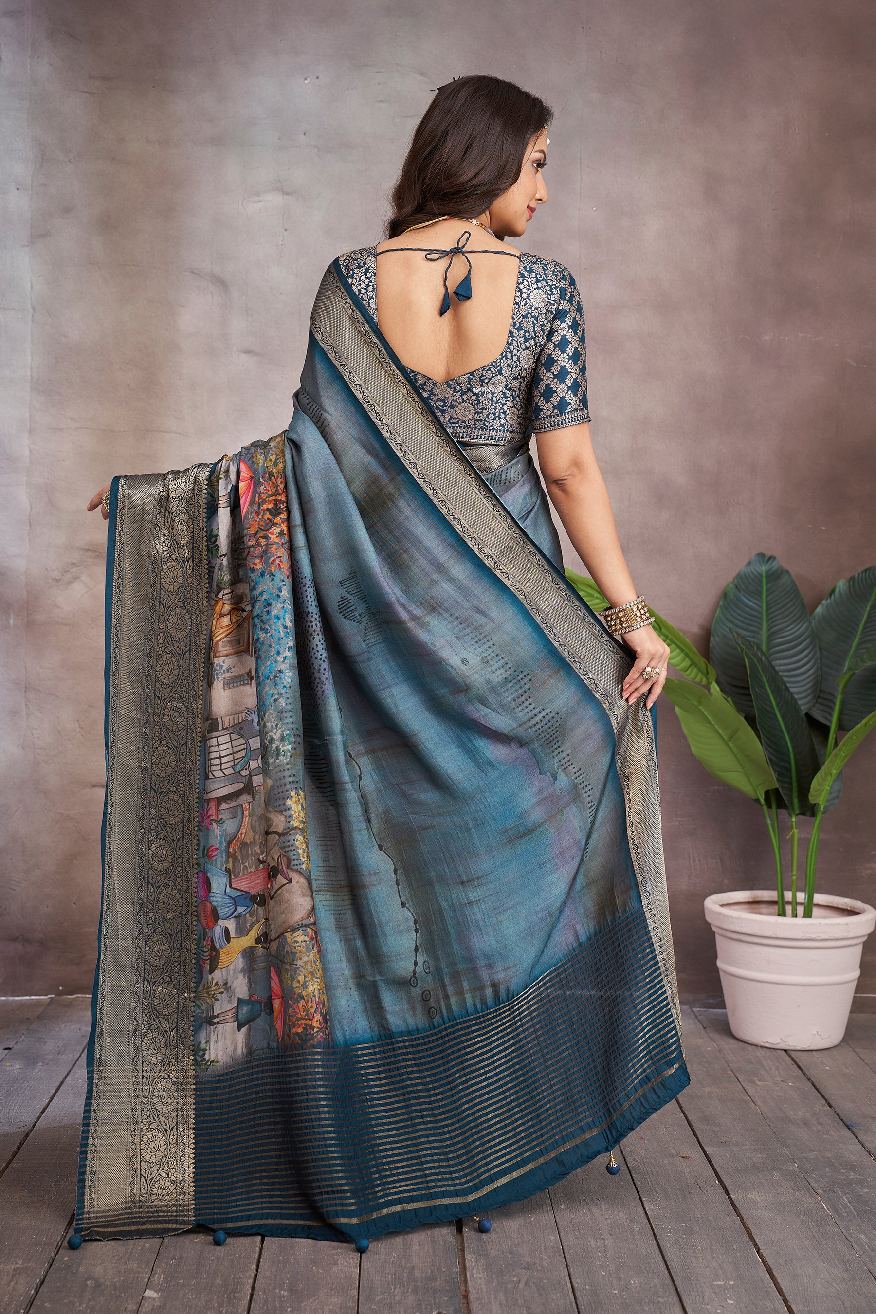 ADHIRA-Elegant Steel Blue Scenic Printed Saree with Antique Gold Zari Border and Designer Black Woven Blouse for Festive & Ethnic Wear